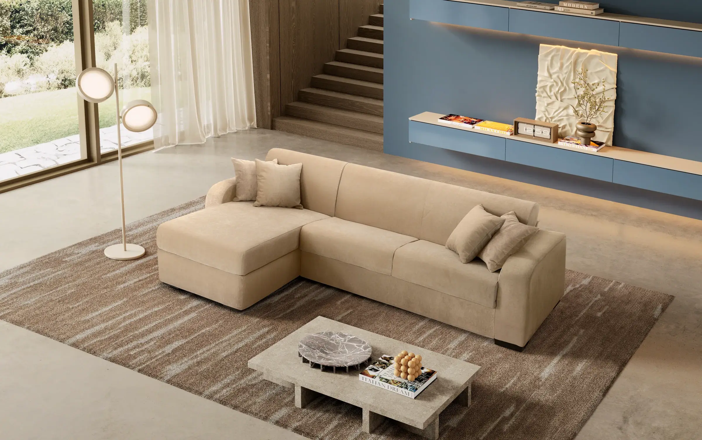 Divano letto Azalea beige con penisola in un living con scala e parete azzurra